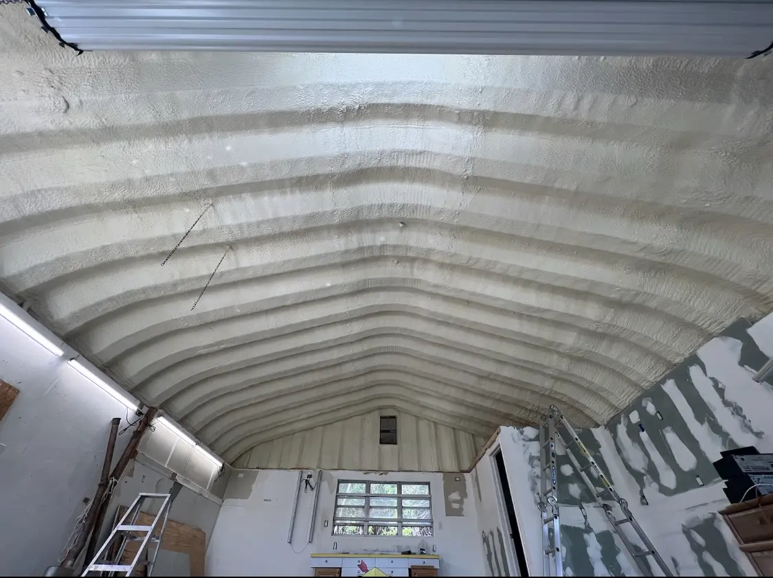 Spray polyurethane foam applied to the underside of a metal roof deck in Carencro